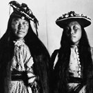 Portrait of Hattie (left) and Jennie (right) wearing Western style dresses and hats. This photograph was taken in a studio at Fullerton, Nunavut, 1904